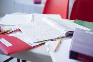 workbook and folder on table for homeschooling during lockdown