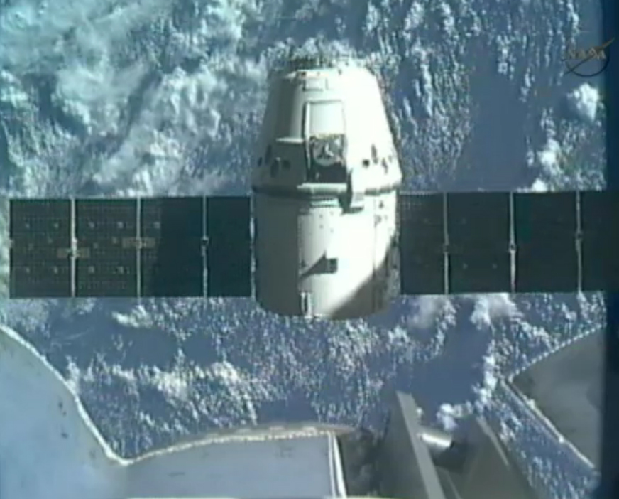 SpaceX&#039;s first Dragon space craft to the International Space Station backs away from the Canadarm2 robotic arm to begin the return trip to Earth on May 31, 2012