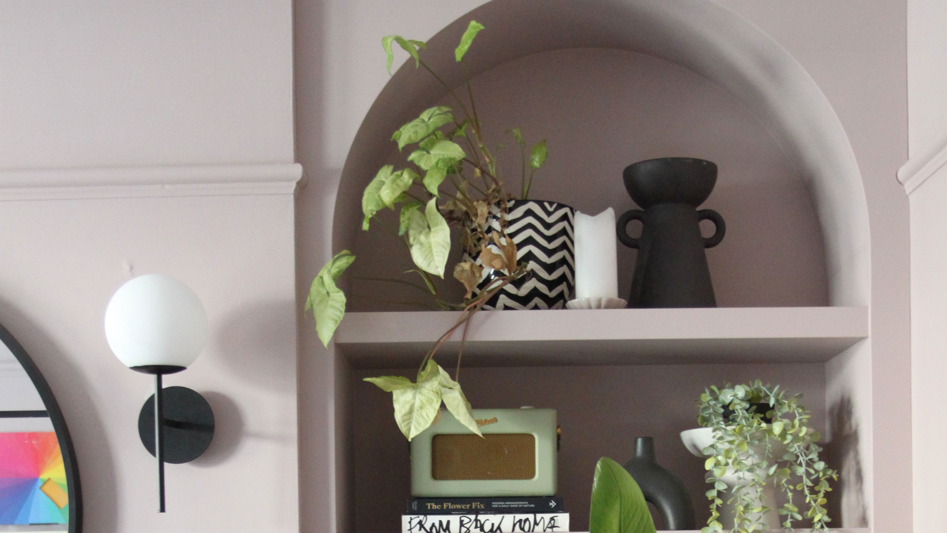 Pale pink living room with arched built-in bookcases