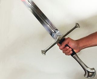 A photo of a hand holding a sword