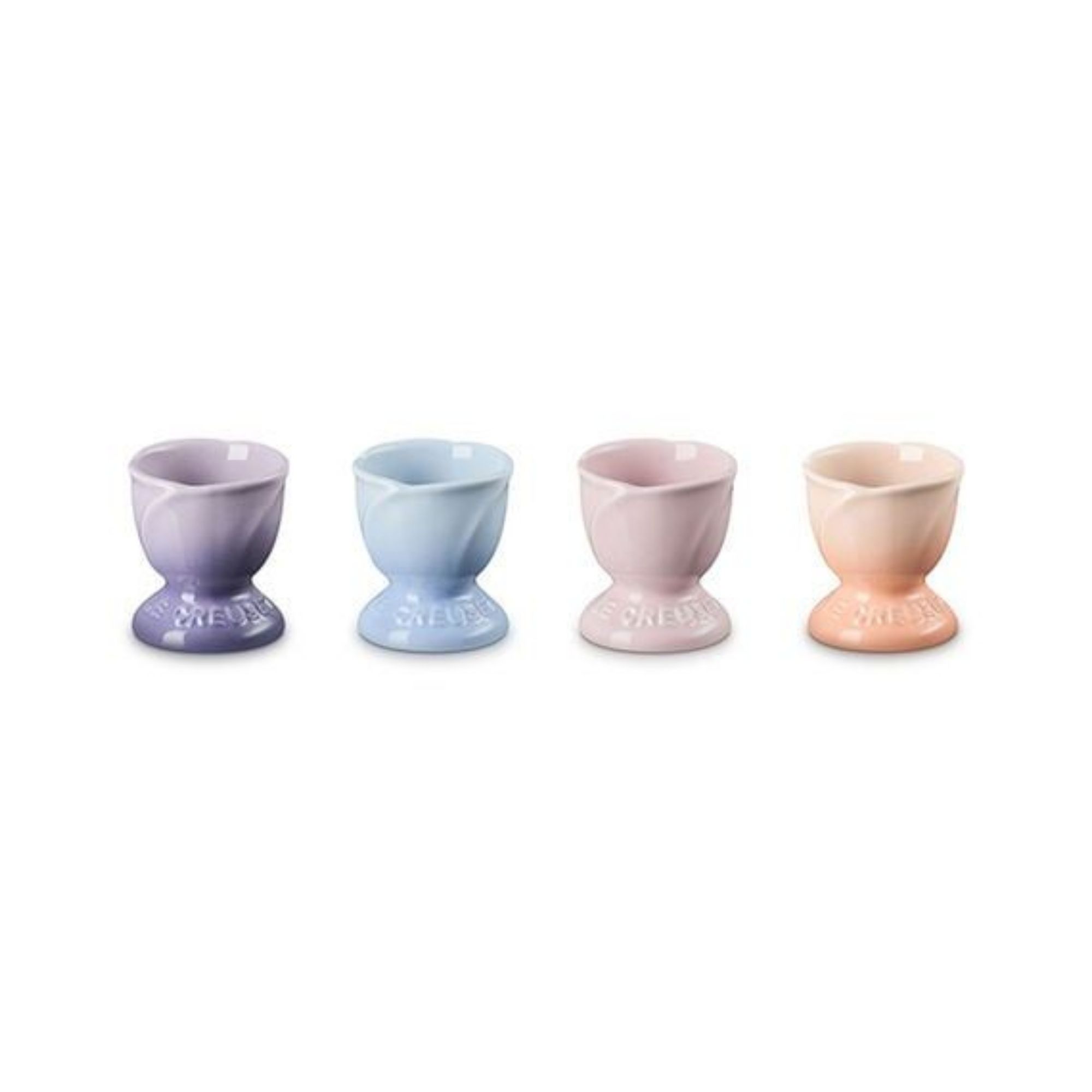 Four egg cups designed to look like tulip flowers, in purple, blue, pink, and peach