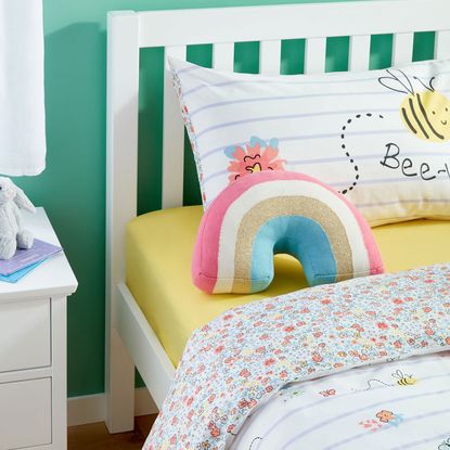 kids room with turquoise green wall and wooden white bed on wooden floor