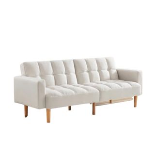 A white sleeper sofa with wooden legs