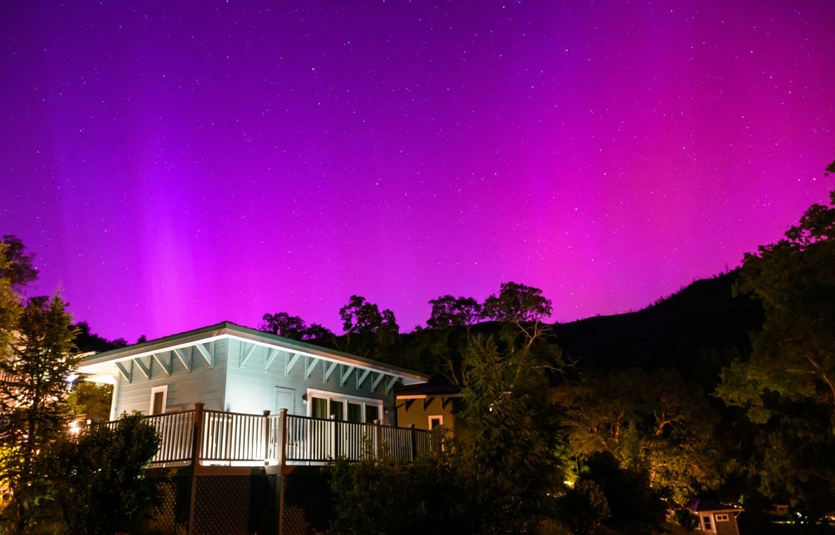 Northern lights or aurora borealis illuminate the night sky over a camper's tent north of San Francisco in Middletown, California on May 11, 2024. The most powerful solar storm in more than two decades struck Earth, triggering spectacular celestial light shows from Tasmania to Britain -- and threatening possible disruptions to satellites and power grids as it persists into the weekend.