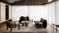 chic, neutral living room with togo sofas and a rug beneath