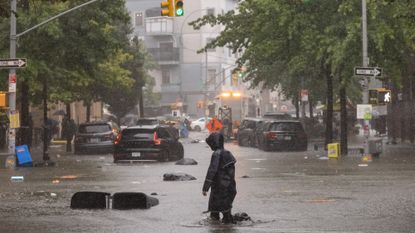 Person standing in NYC flooding.