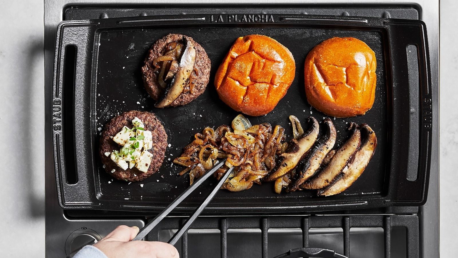 Griddle with burgers and buns