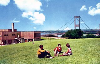 Three Childrens sitted on a Picnic Area.