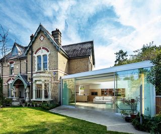 contemporary single story glass extension attached to detached Victorian villa