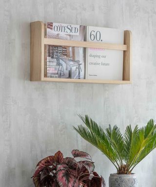 Wall mounted wood magazine rack.