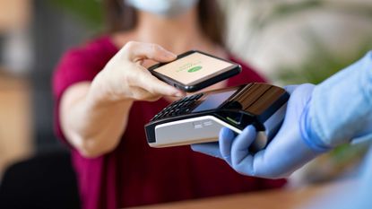 Photo of person paying with phone app