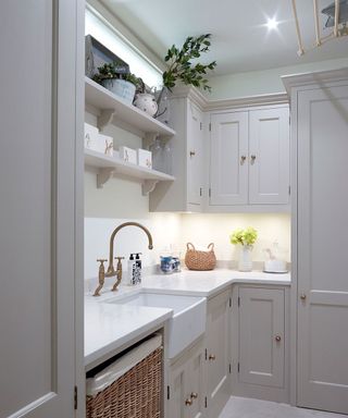 White painted shaker-style utility room with open shelving