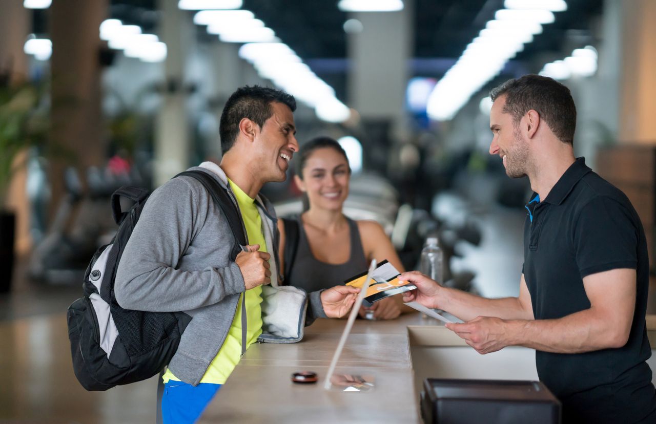 Man and woman signing up for a gym