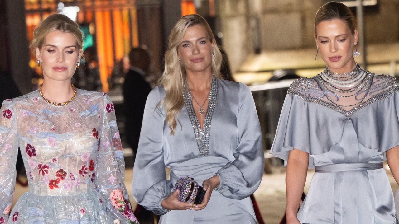 Lady Kitty Spencer, Eliza Spencer and Amelia Spencer walking outside at night while wearing blue evening gowns