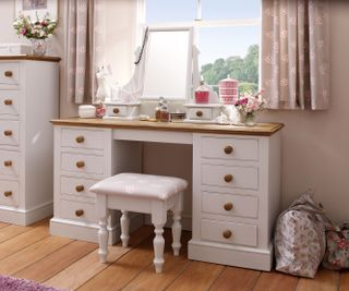 girl's bedroom with painted white dressing table with drawers