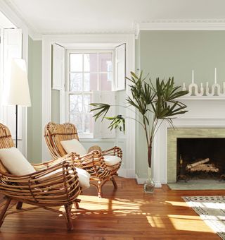 soft green living room with wicker chairs by Benjamin Moore