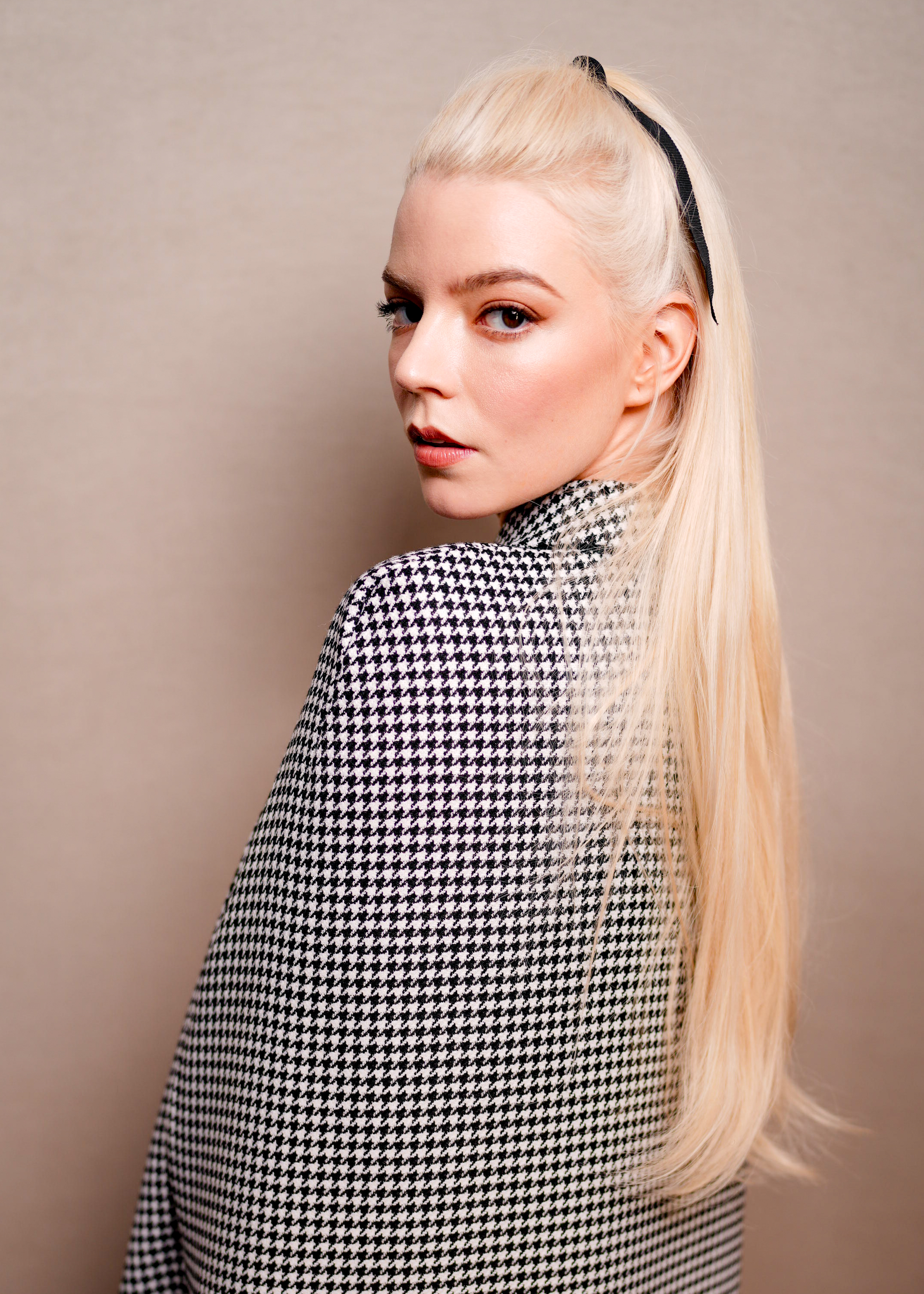 Anya Taylor Joy with a bow half up half down hairstyle