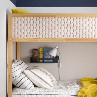 Kids bedroom with IKEA bunk bed and IKEA spice rack to hold books