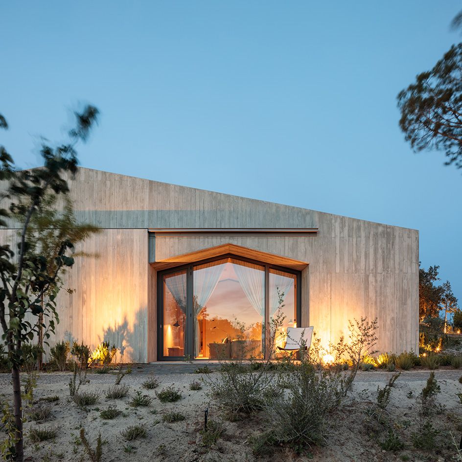 dusk shot of concrete pavilion exterior at pa.te.os hotel in portugal