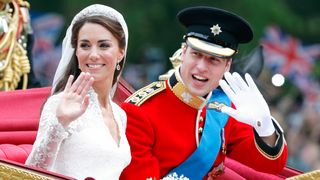 Kate, wearing her wedding dress, and Prince William, wearing his red tunic uniform of the Irish Guards, wave from a carriage on their wedding day in 2011