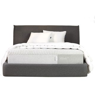 Image shows the Casper Wave Hybrid Snow mattress on a dark grey fabric bed frame