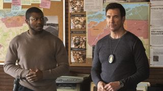 Edwin Hodge as Special Agent Ray Cannon and Dylan McDermott as Supervisory Special Agent Remy Scott standing next to each other in FBI: Most Wanted season 5