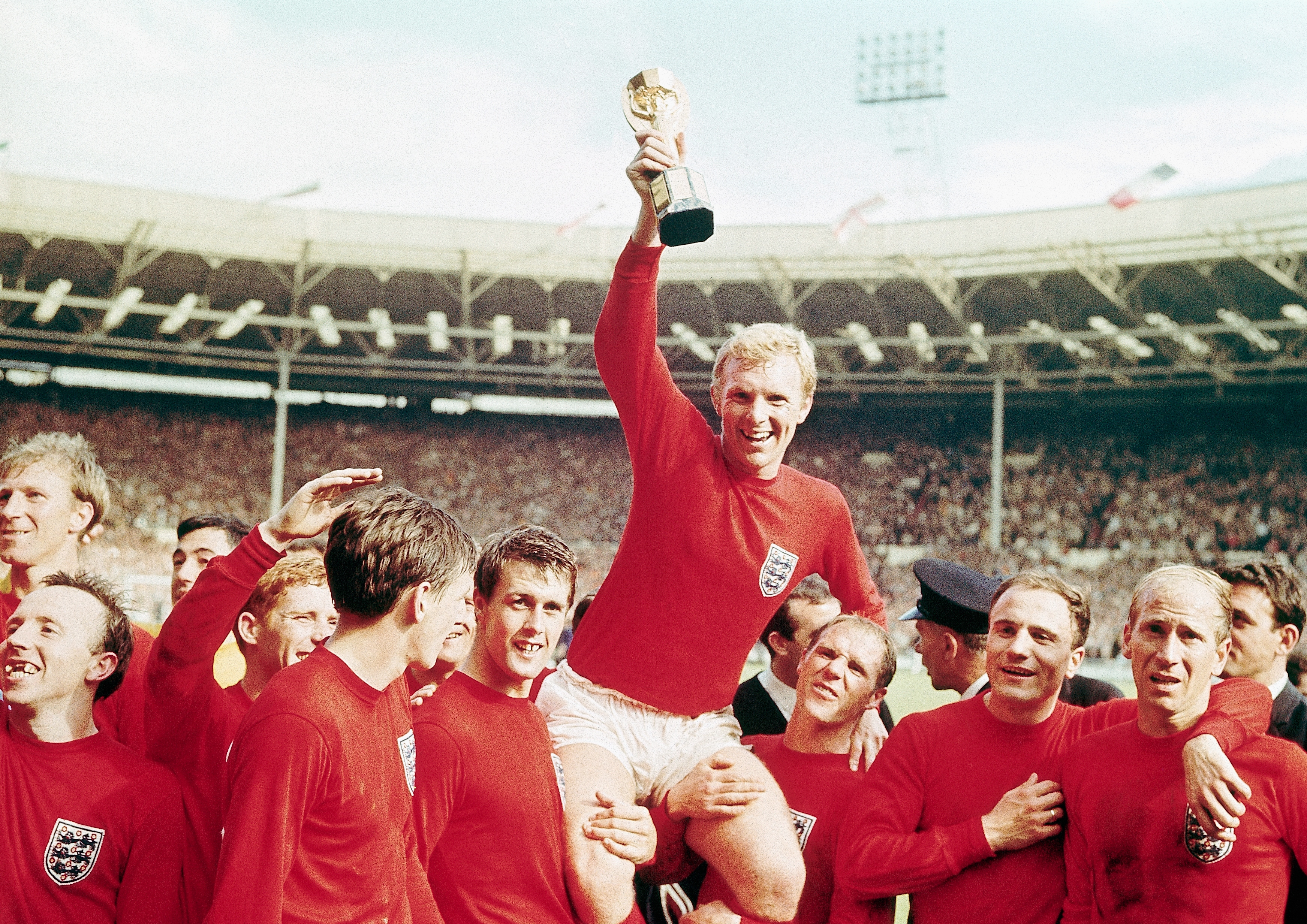 England captain Bobby Moore holds the Jules Rimet trophy aloft after victory over West Germany in the 1966 World Cup final