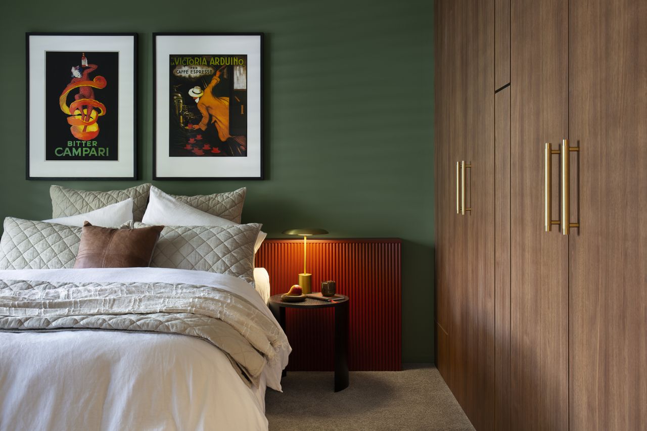 A bedroom with a built-in wardrobe, green walls, and orange wallpanelling