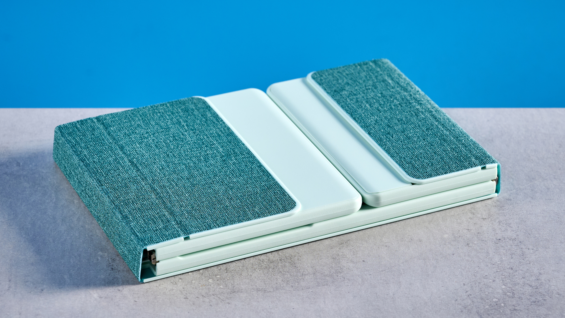 Seenda Foldable Bluetooth Keyboard with Touchpad pictured in front of a blue background.