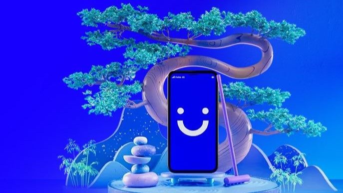 Visible logo on phone next to bonsai plant