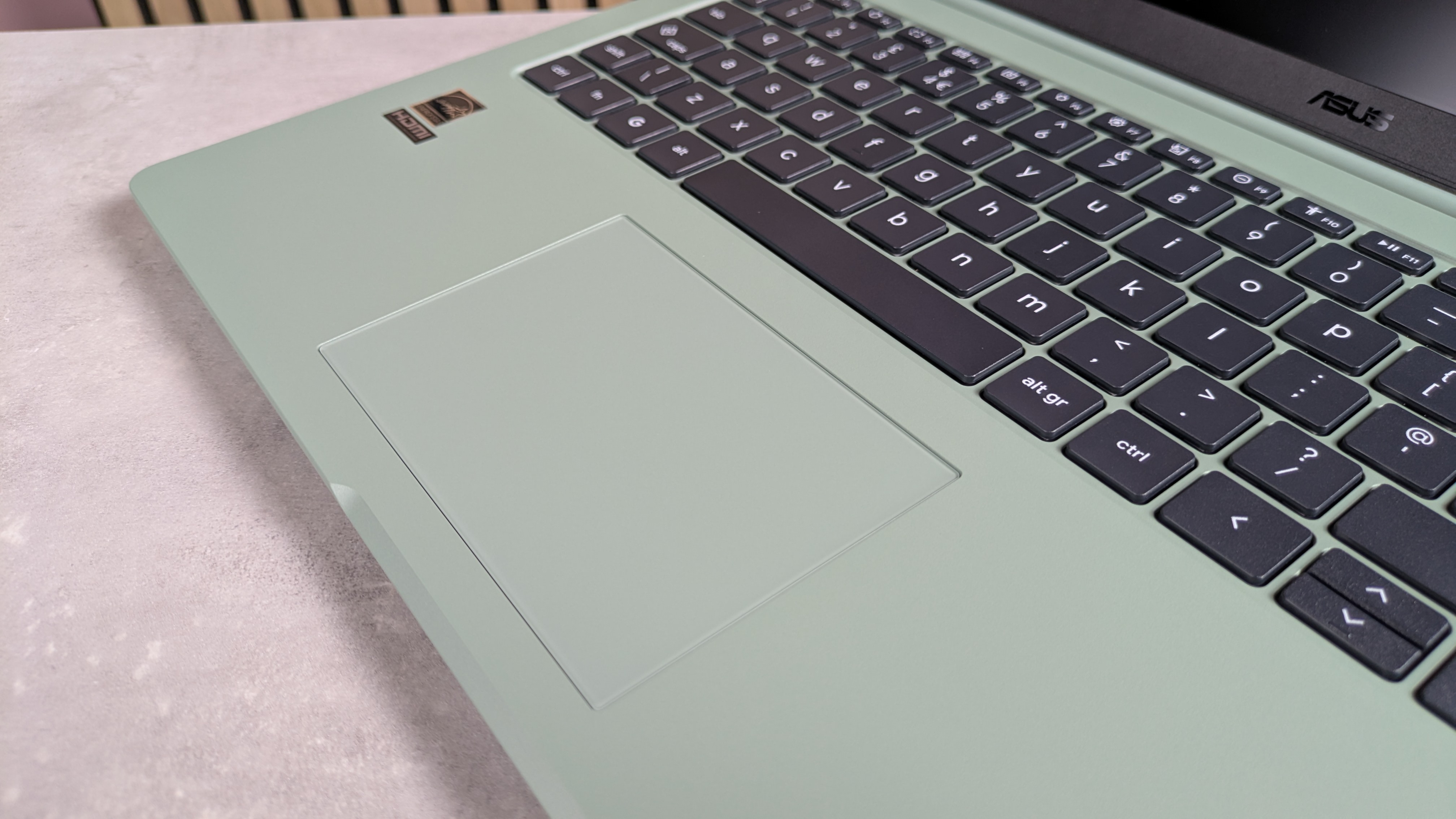 Close-up of touchpad on ASUS Chromebook CX15, open on desk