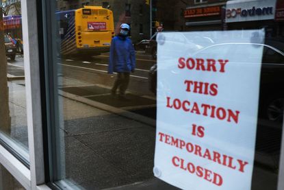 A sign alerts customers that a business in Queens is closed
