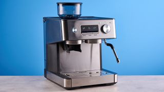 the gevi espresso machine with grinder showing its bean hopper, steam wand, and control screen with a silver dial and drip tray