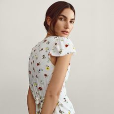 Lily Aldridge wears a white floral dress from the Gap x Dôen collaboration