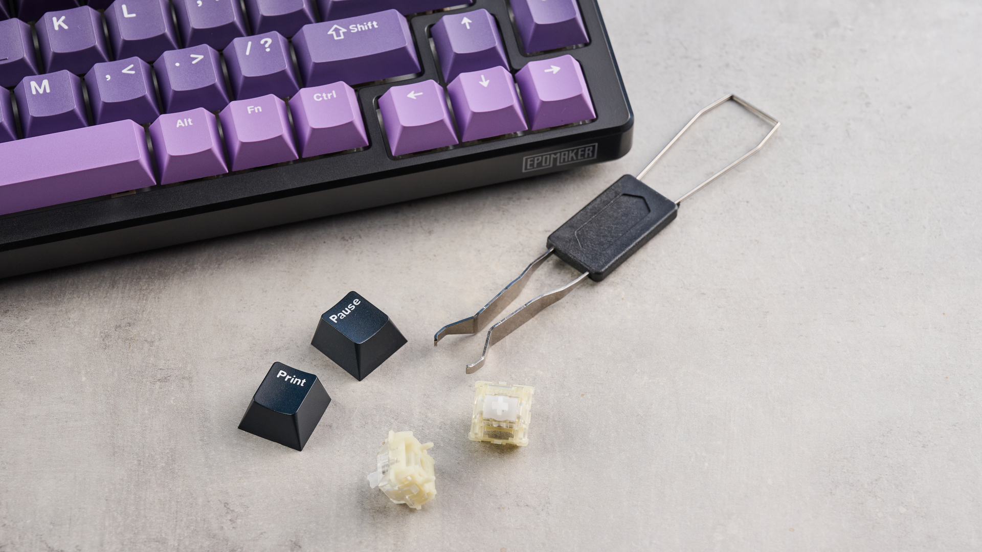 The Epomaker HE75 Mag with the included switch puller and two of its switches and keycaps removed