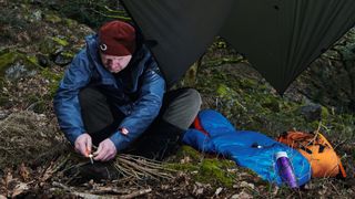 Survival skills and gadgets 101: a man uses a flint and steel to spark a fire