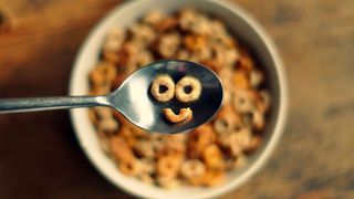 bowl of breakfast o's, spoon with o's in the shape of a smiley face