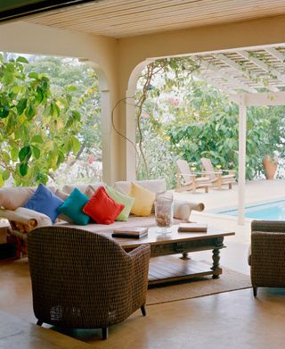 enclosed patio with sofa and pool