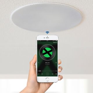 white ceiling wireless speaker with iphone