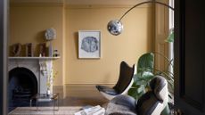 Pale yellow living room styled with mid-century style furniture 