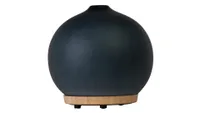 Homedics Ellia Adore essential oil diffuser, large dark globe on top of a wooden base