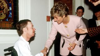 Princess Diana shaking hands with a man with AIDS