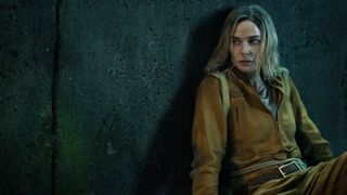 Rebecca Ferguson leans against a wall in "Silo" season 2