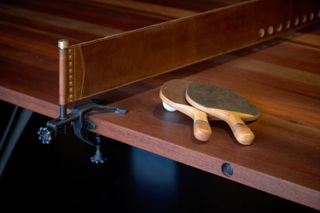 Detail of wooden table tennis table and bats