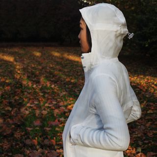 Woman wearing white recycled hoodie outdoors