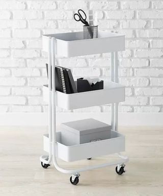 A white three tier rolling cart