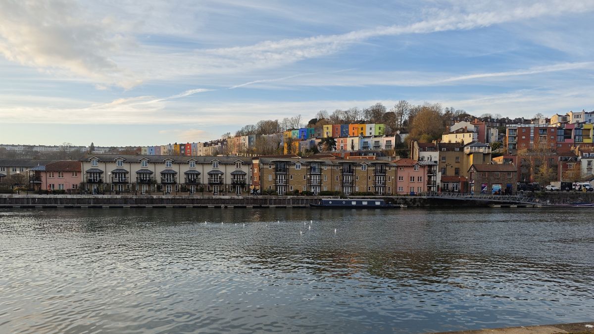 Image of colorful houses behind a river on a sunny day, shot on a Poco F7 Pro phone