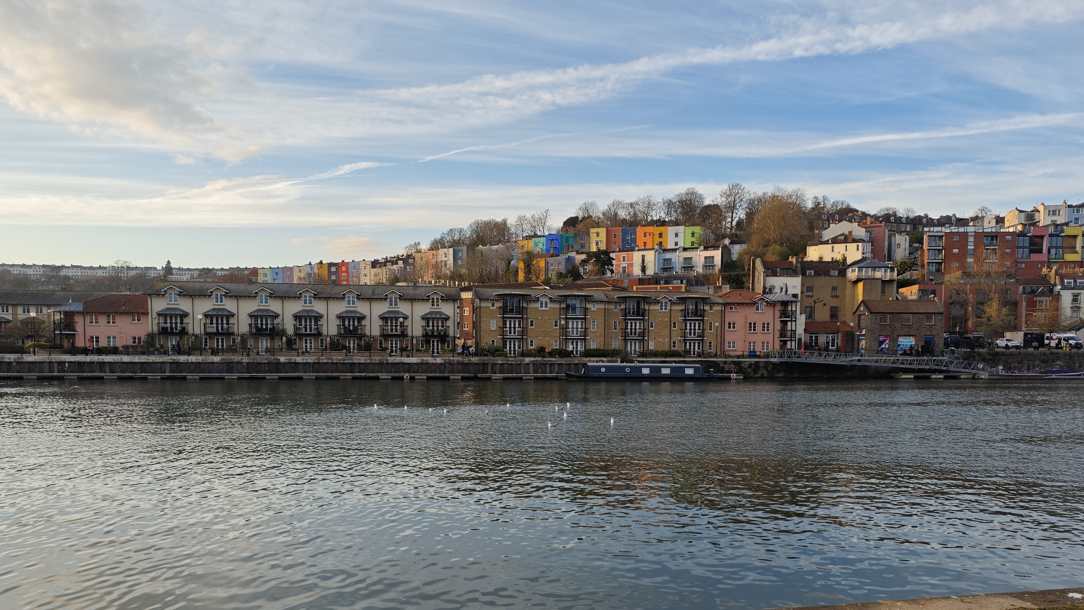 Image of colorful houses behind a river on a sunny day, shot on a Poco F7 Pro phone