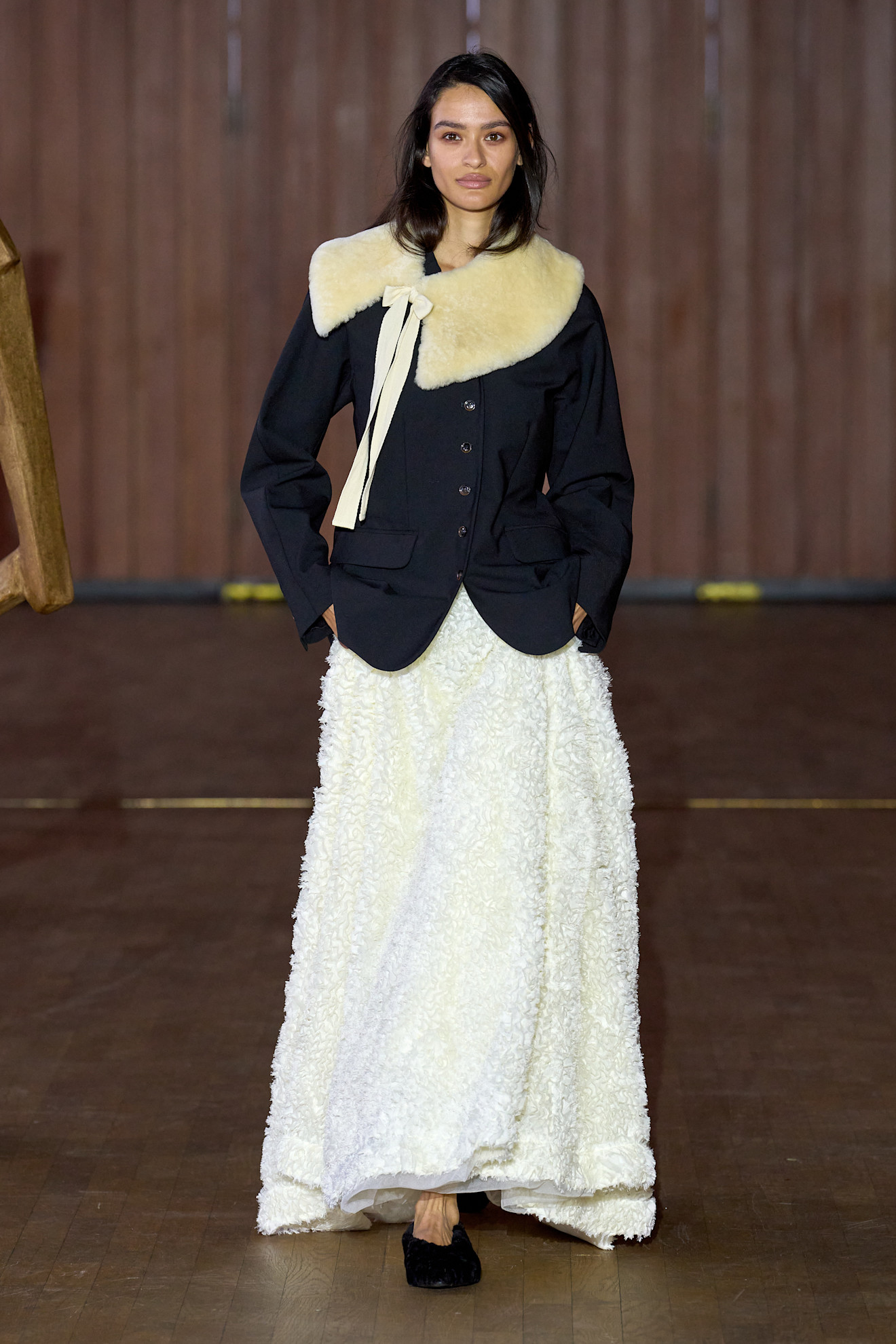 a model wearing a fur collar over a blue blazer