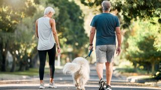 Couple taking dog for a walk